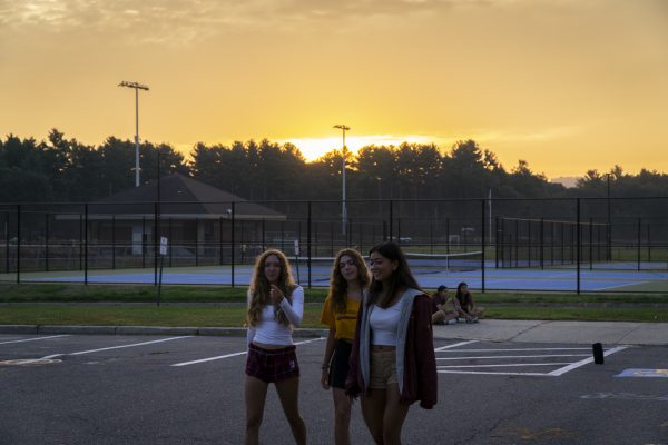 Seniors Audrey Helwig, Colleen Donohoe and Mackenzie Clark walk around and talk with one another early in the morning during Senior Sunrise on Sept. 8.