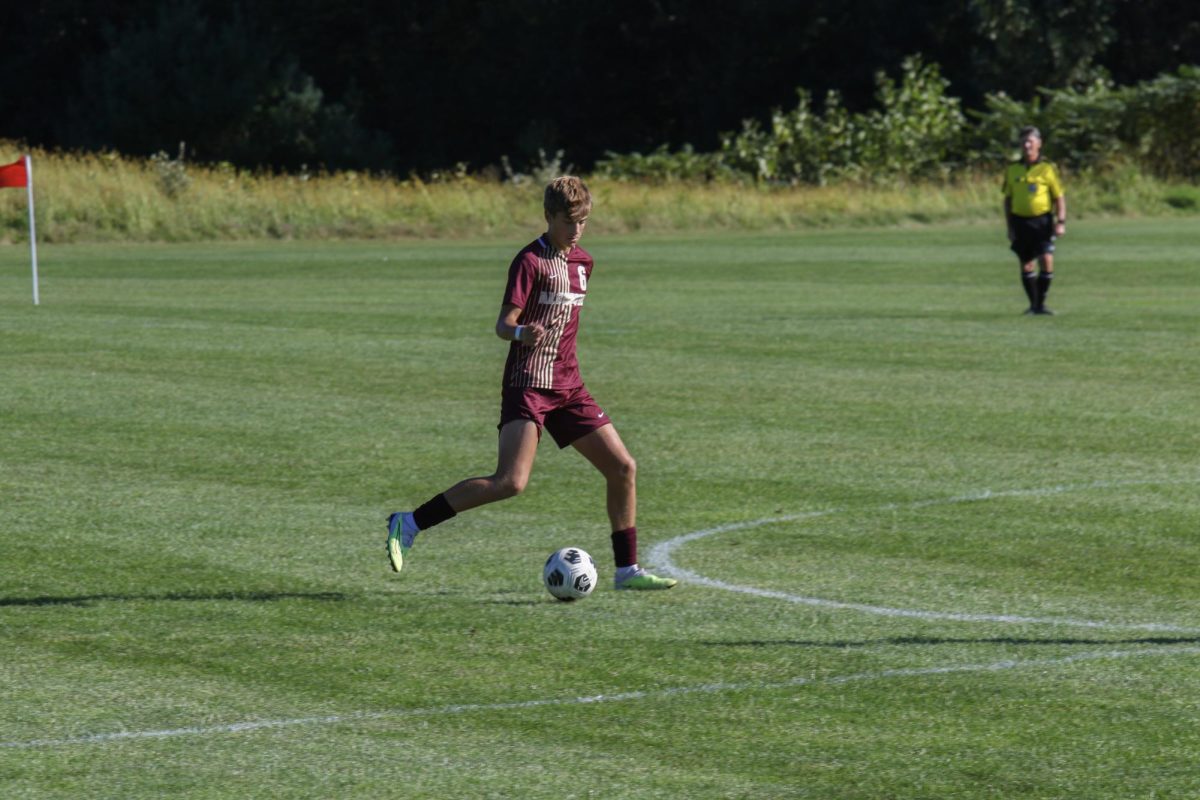 Junior Max Oelkers moves the ball up the field during the boys soccer game against Leominster on Sept. 14.