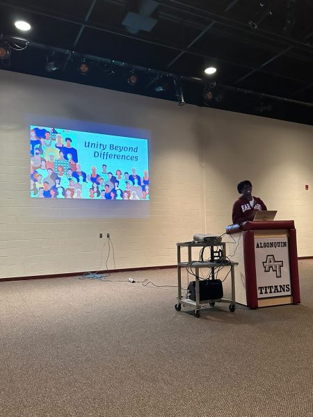 Unity Beyond Differences founder, senior Patrick Biamou, leads a club meeting in the Black Box Theater after school on Sept. 14.