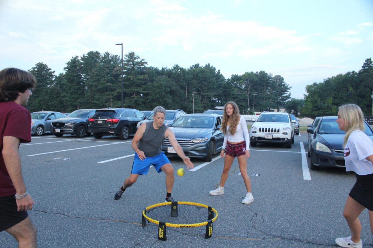 Principal Sean Bevan plays Spikeball with seniors Cole Gowdy, Audrey Helwig and Tessa James at Senior Sunrise on Sept. 8.