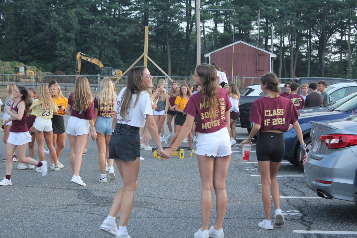 Seniors laugh and talk in the parking lot during Senior Sunrise on Sept. 8. The event theme was Gonk Pride.