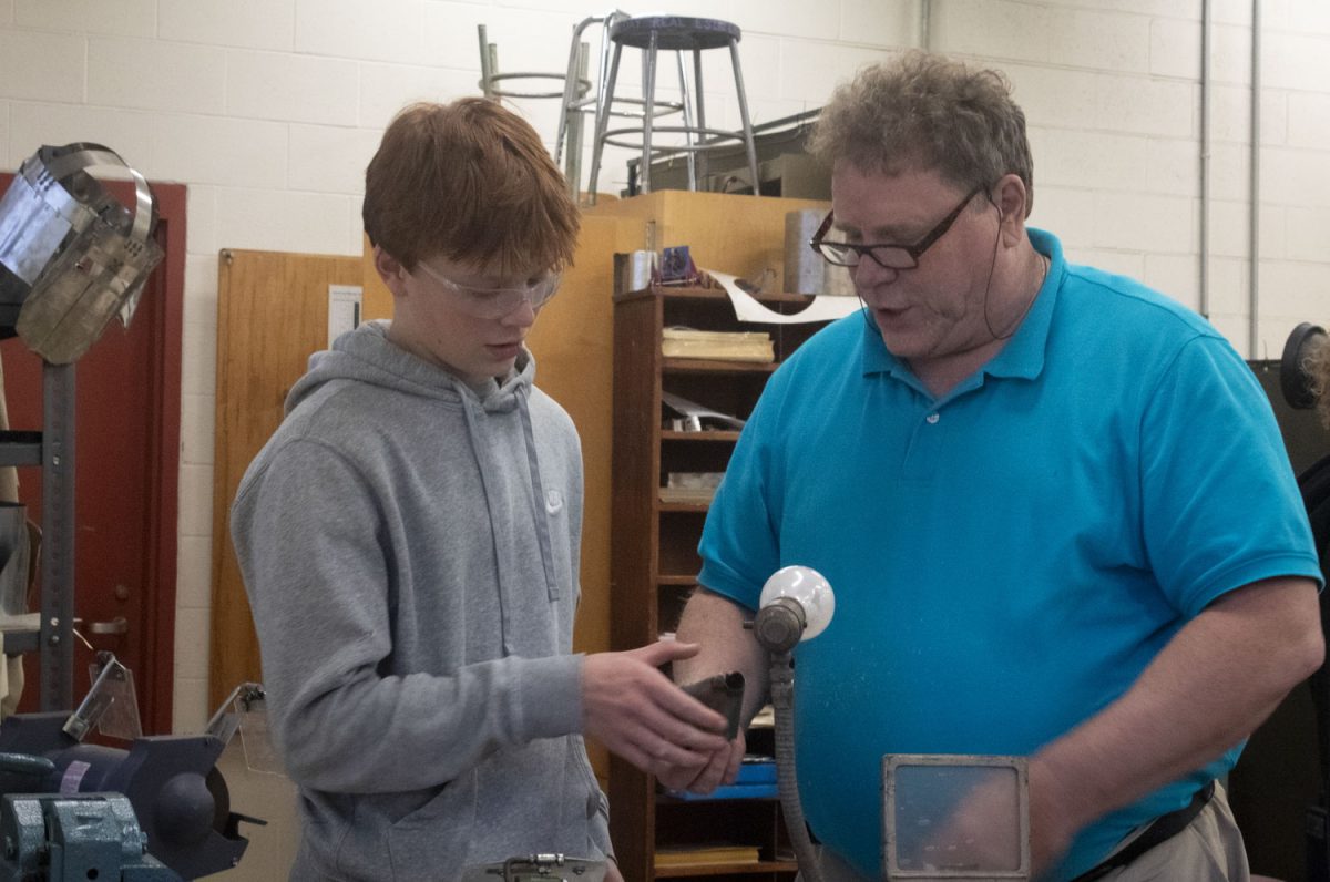 New Wood Tech and Engineering teacher Dr. Bruno Nosiglia helps sophomore Brogan Mulkerin with his current project.