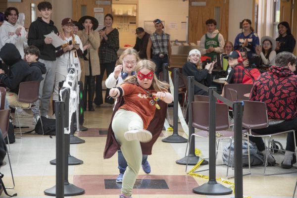 Olivia Cheney walks the runway followed by Sofia Roumiantsev at the Halloween Costume Contest during lunch.