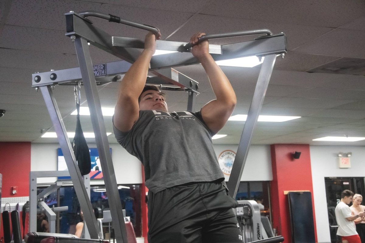 Senior Tylor Doherty does pull-ups to warm up for a workout. Doherty holds the state deadlift record of 529 pounds.