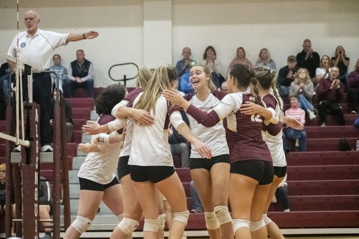 Players on the girls volleyball team celebrate after scoring a point during their game against Plymouth South on Nov. 7. Algonquin won 3-1 to advance to the Elite Eight round of the state playoffs.