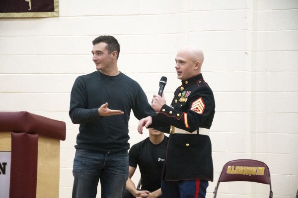 Army Veteran and Class of 2019 graduate Tony Massaglia hands the microphone off to Marine Staff Sergeant Nicholas Lamothe when answering a question from the audience.