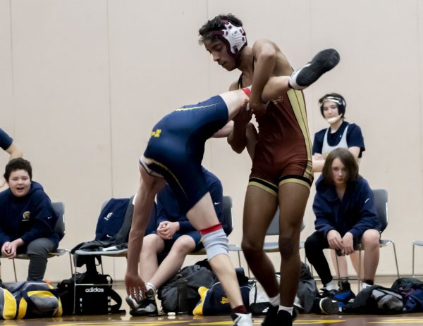 Junior Hendrill Costa throws his opponent onto the floor during the Wrestling meet against Quabbin at Algonquin on Wednesday, Jan. 10, 2024.