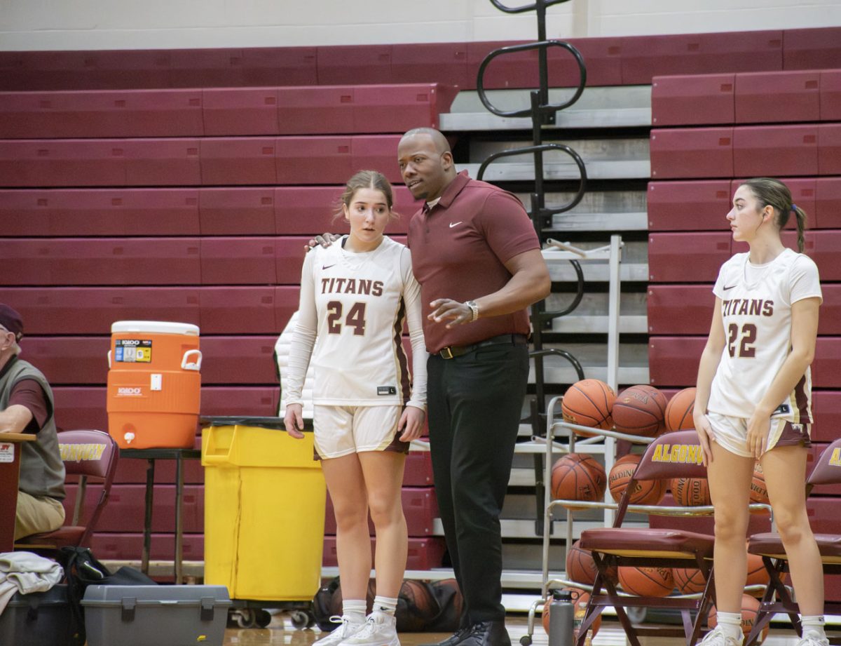 New girls varsity basketball Coach Kashwan Hampton talks to junior Brooke Adams on the sidelines on Dec. 14, 2023, during a hard fought 17-42 loss to Nashoba.