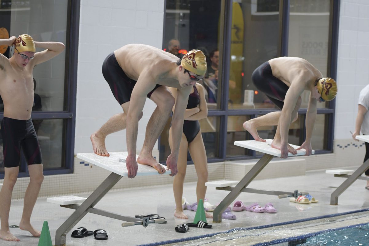 Senior captain Axel Soderquist gets ready to dive off a diving block; the boys team won their meet on Jan. 8, 2024.
