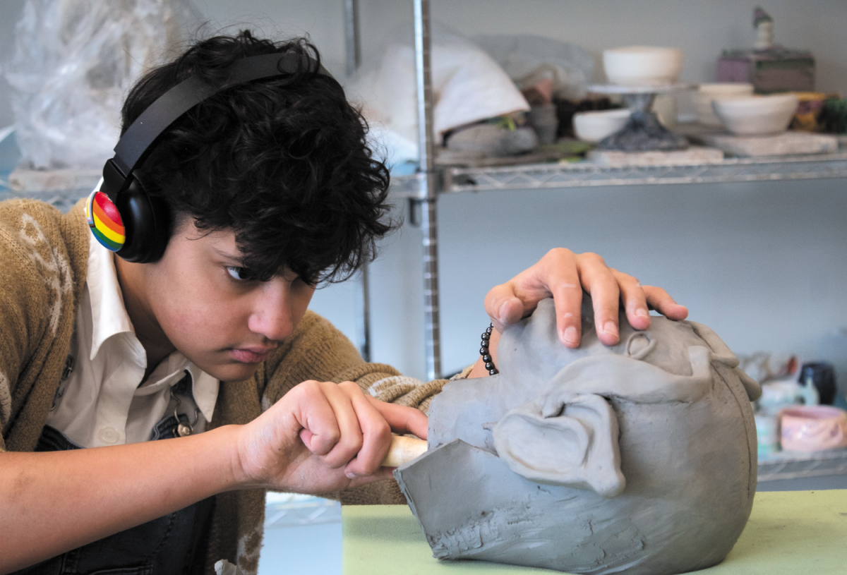 One of the electives Algonquin offers its students is Ceramics. A project they work on in the class is making a bust of a person. In the class, sophomore Axl Whiteman carves the inside of his sculpture on Jan. 4.