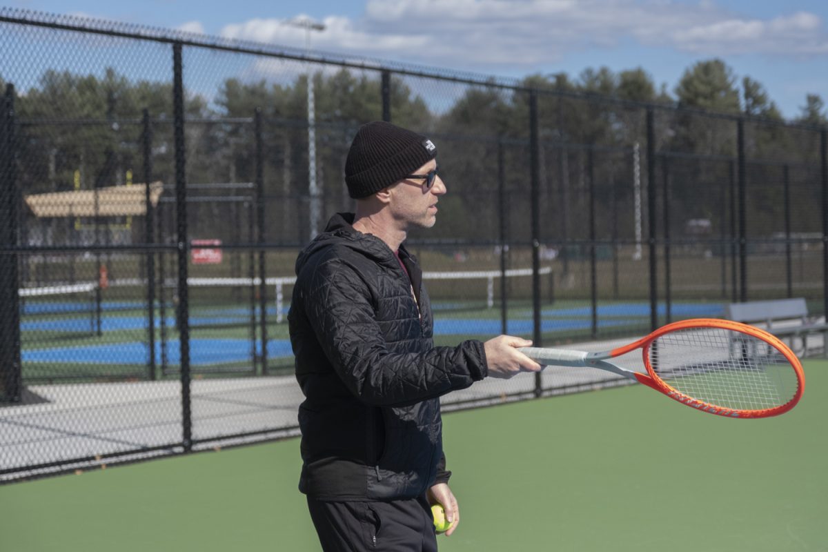 At the girls' tennis tryouts on March 18, new coach Dan Welty explains the first activity that the team will be doing.