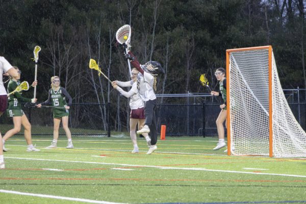 Junior goalie Sadie O’Connell saves a shot from Wachusett in a tough game on April 2, which the Titans lost 14-17.