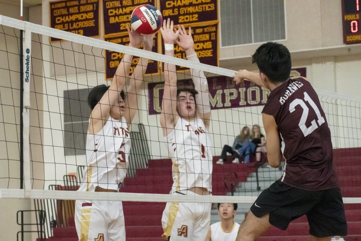 Senior Eric Tam (5) and sophomore Gavin Butterfield (1) block a spike from a Millis player at their winning, 3-1 game on April 23, 2024.