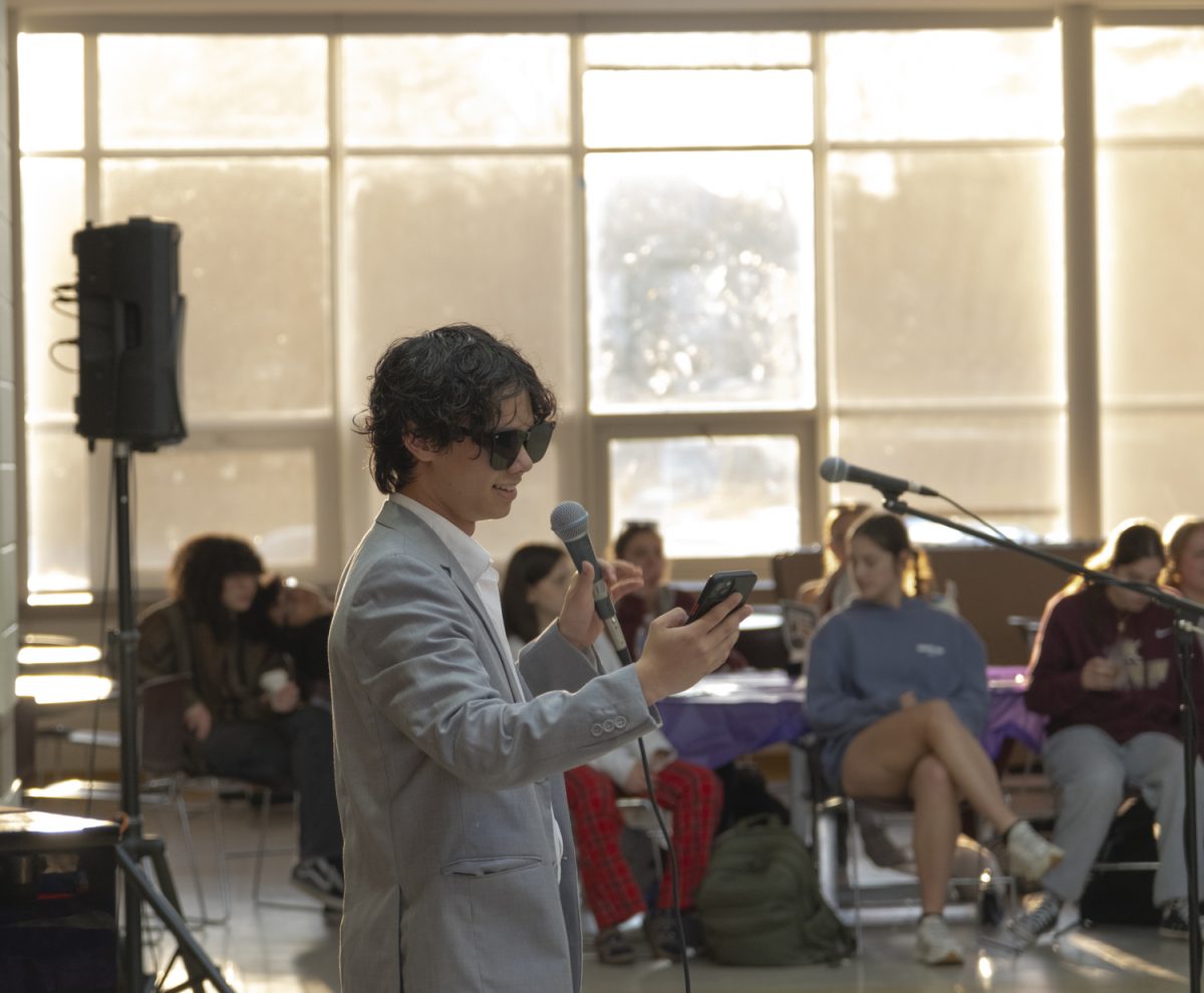 Senior Oliver Kubik makes the opening speech during the Tri-M coffeehouse on May 1, 2024.