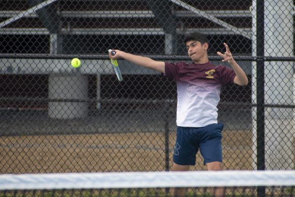 Freshman Kunal Jandu hits the ball to the opponent at their home game on May 2.