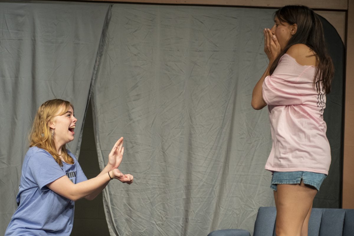 Senior Savannah Staples (left) proposes to senior Juliana Oyola (right) during their improv game. Oyola started the game with a monologue about getting caught in the school parking lot going 140 mph. Getting ideas from the audience, the performers on stage improvise during Improv Night on May 16.