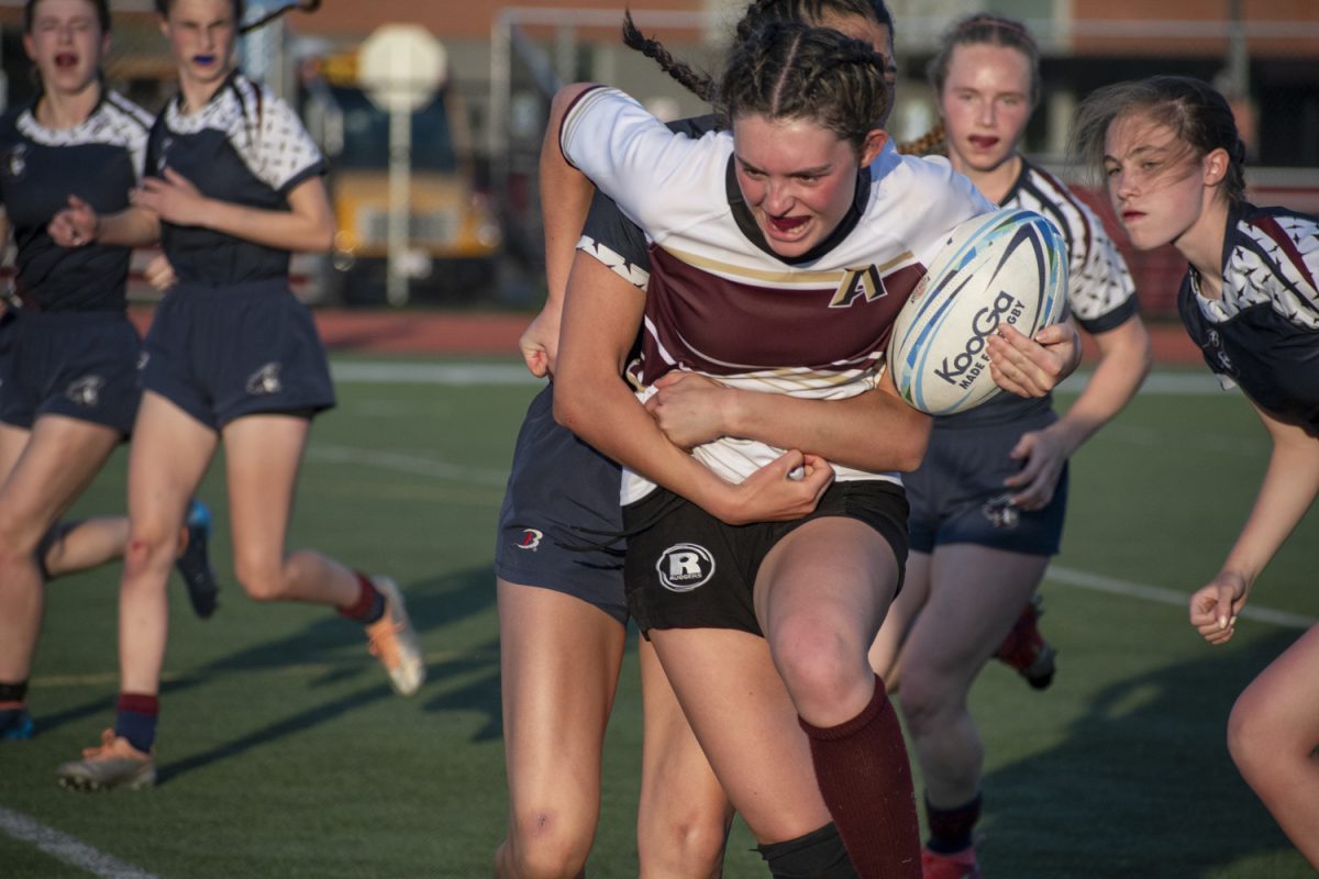 Senior+Eleni+Chacharone+tries+to+escape+a+Belmont+players+grasp+during+their+on+May+22.+The+team+is+entering+the+state+tournament+as+the+number+two+seed.