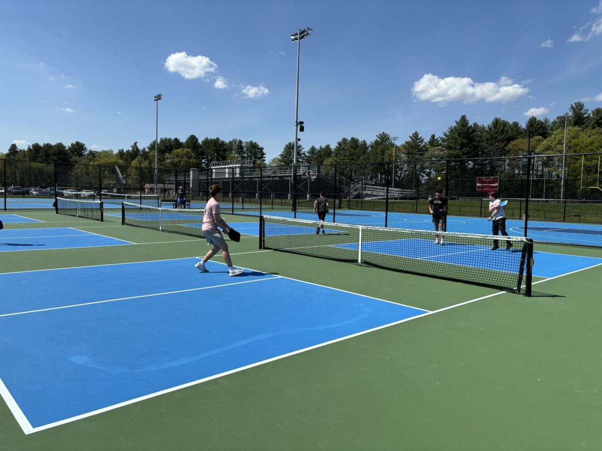Members of the Pickleball Club warm up before their meeting on May 14.