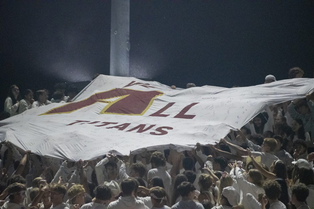 During halftime, a banner reading "We Are All Titans" is passed up and down the student section on Sept. 6.