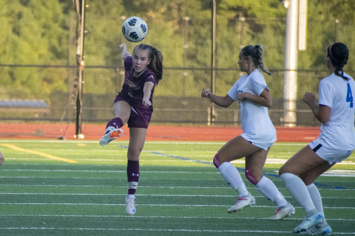 Junior Ella Timmins (2) kicks the ball up the field, passing to her teammate during Algonquin's 4-0 win against Leominster on Sept. 10.