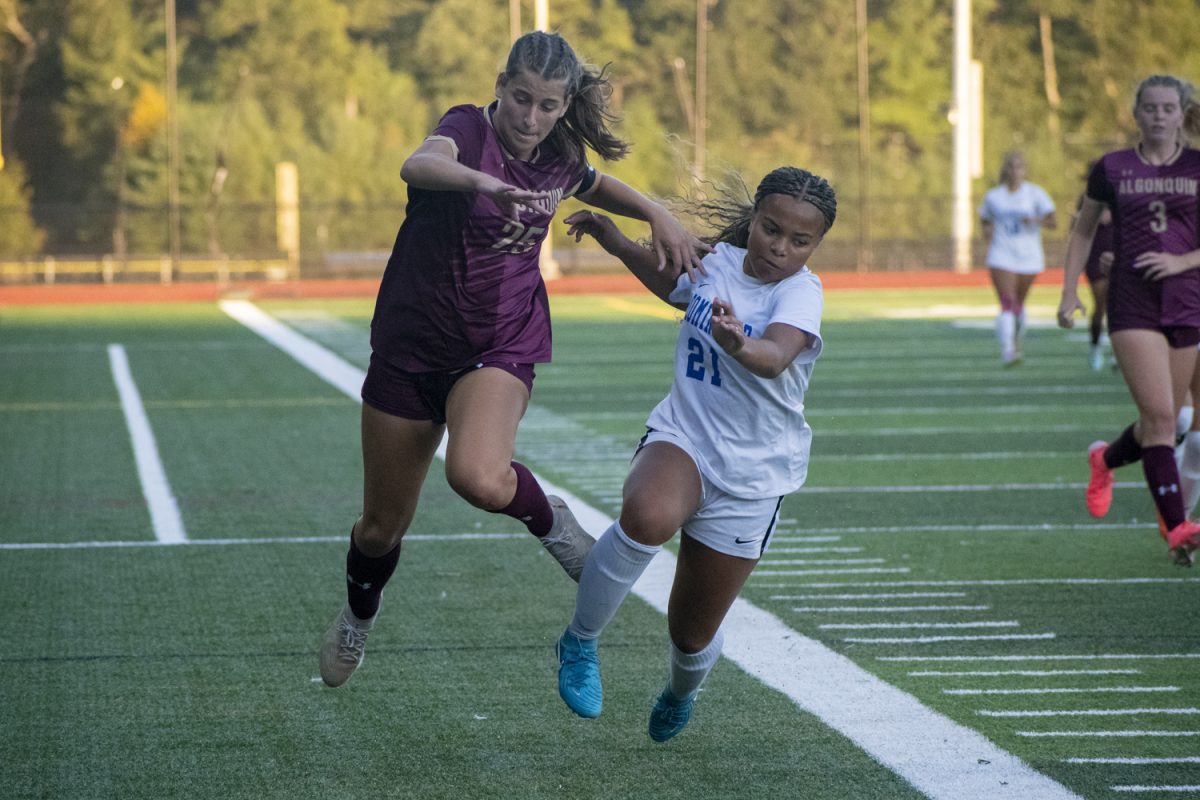 Senior captain Katie Richmond (25) is pushed by a Leominster opponent on Sept. 10.