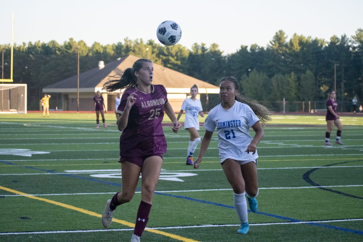 Senior captain Katie Richmond (25) watches the ball in the air with a Leominster opponent on Sept. 10.