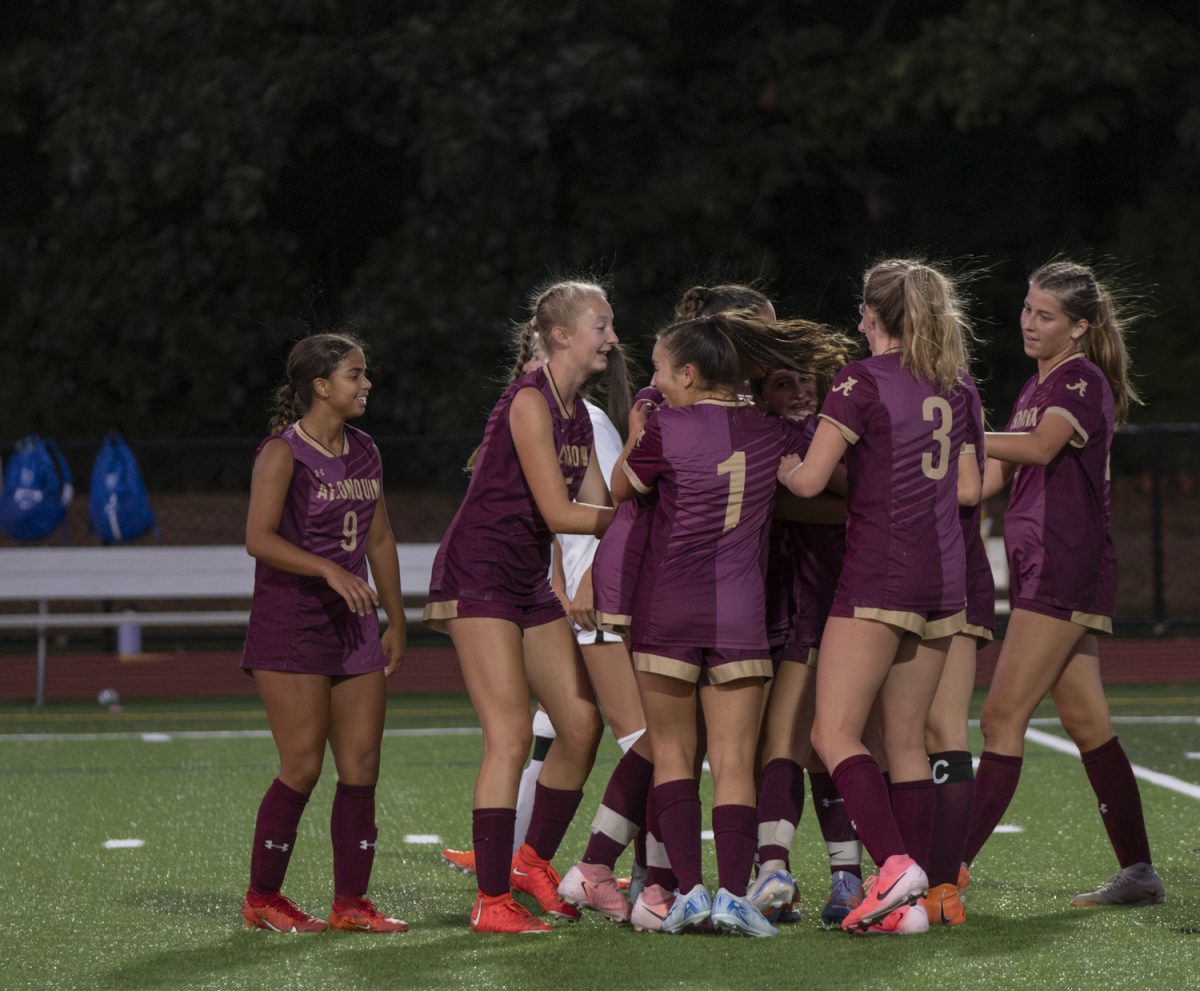 The girls' varsity soccer team celebrates their fourth and final goal during their Sept. 10 match against Leominster.