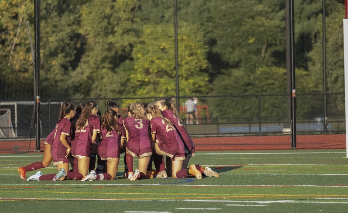 Moments before the Sept. 10 girls' varsity soccer game, the Algonquin team huddles on their side.