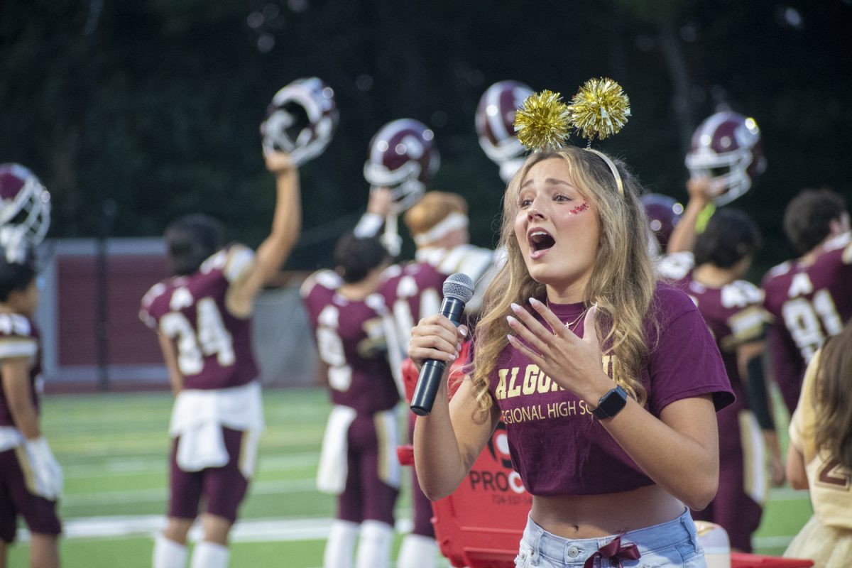 Before Algonquin's game against Doherty on Sept. 13, junior Ava Guckian sings the national anthem.