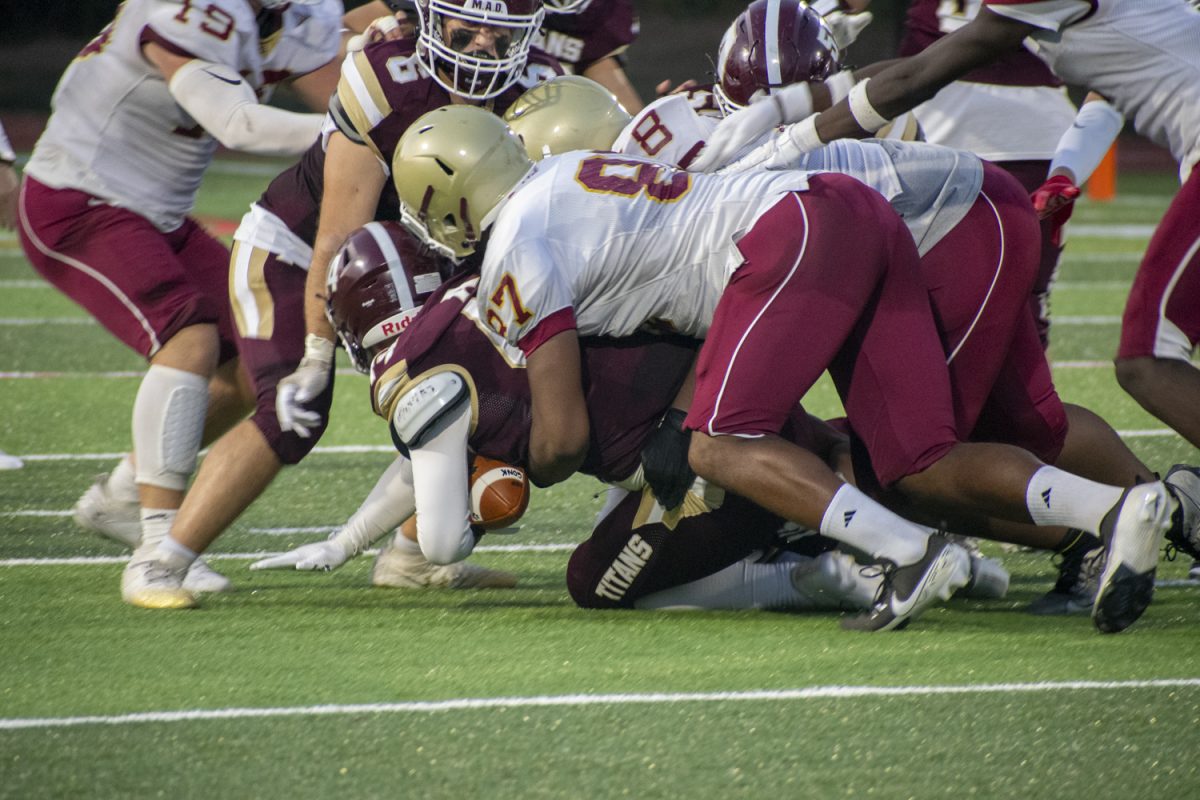 During their 31-14 loss against Doherty on Sept. 13, senior captain Owen Ellsworth (44) is tackled by the opponents.