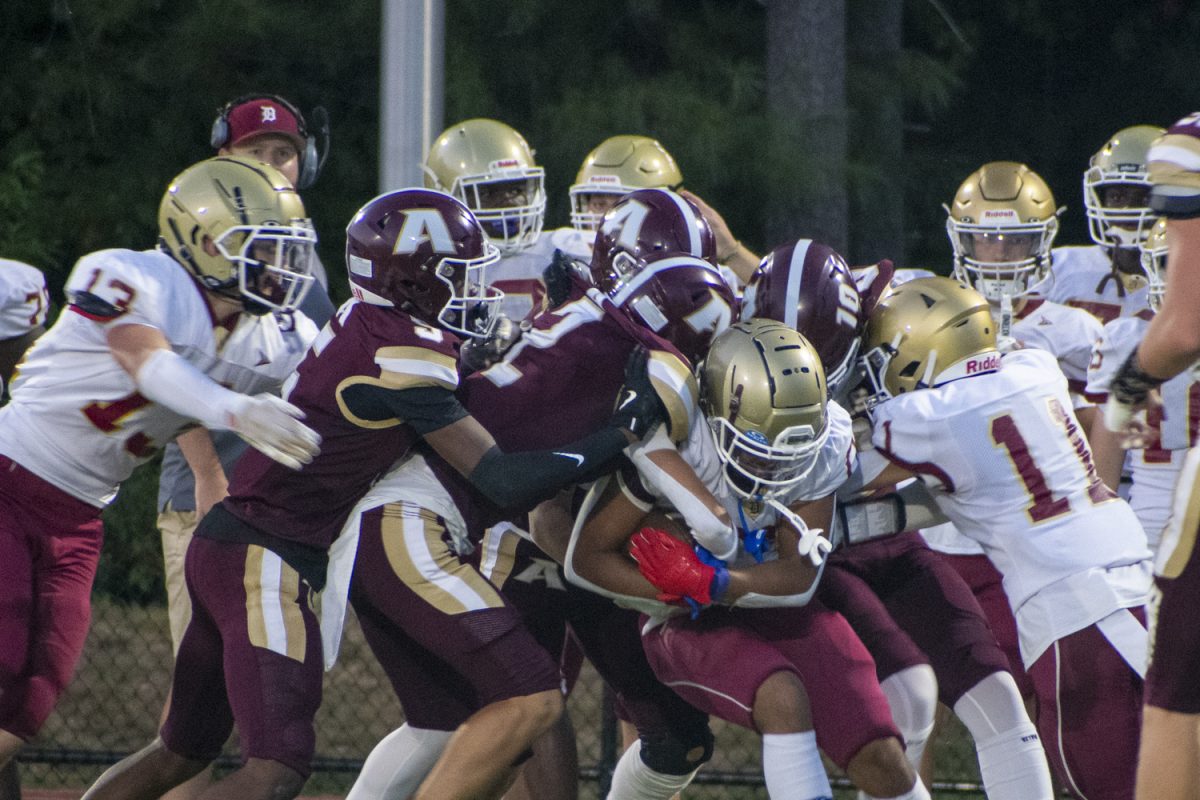 Algonquin football players tackle a Doherty opponent.