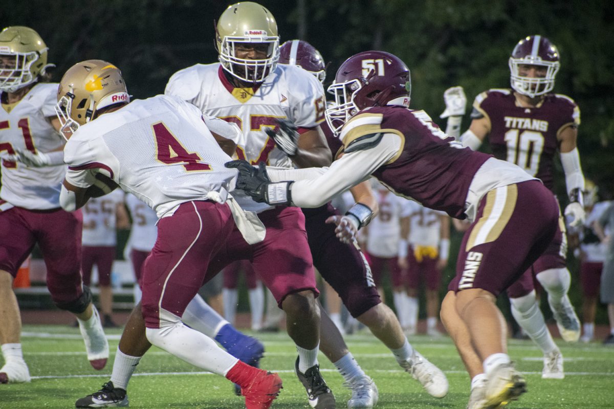 During their 31-14 loss against Doherty on Sept. 13, junior Walter Rogers grabs his opponents shirt but fails to drag him to the ground.