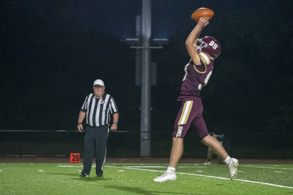 During their game against Doherty on Sept. 13, junior Noah Cutone catches the ball and prepares to kick it.