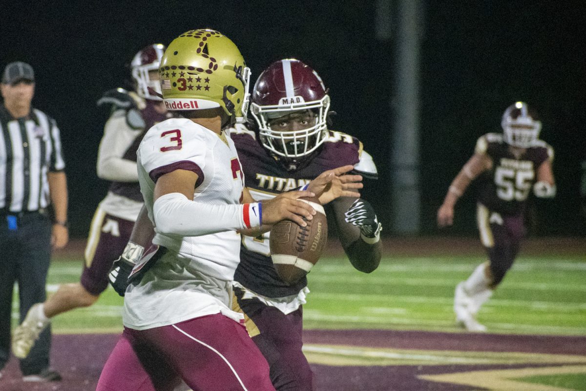 During their 31-14 loss against Doherty Memorial High School on Sept. 13,  junior Preston Biamou looks to tackle a Doherty opponent.