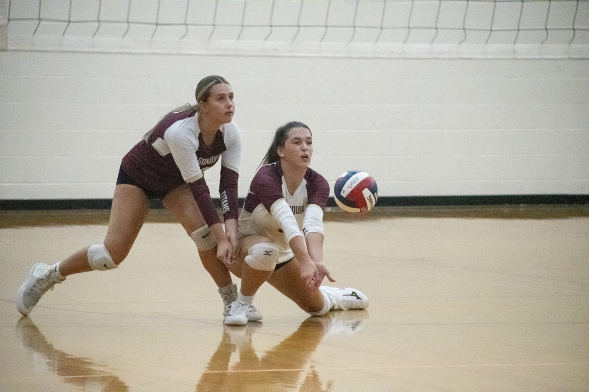 Seniors Julianna Zimmer (left) and Julie Martin (right) ready themselves to receive the ball on Sept. 17.