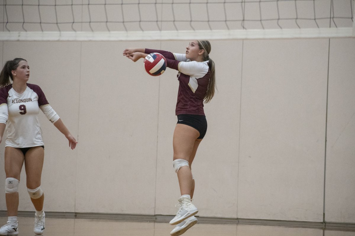 Senior Julianna Zimmer (right) bumps the ball off the side of her arm on Sept. 17.