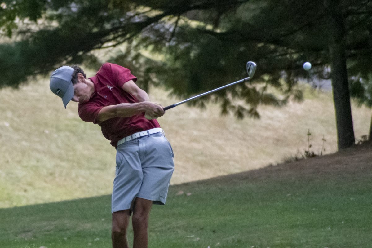 Senior George Skafidas hits the ball upwards towards the hole during their win against Leominster on Sept. 19.