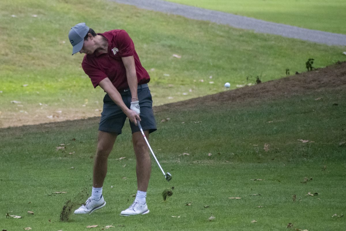 Junior Quinn Shea hits the ball, bringing up some dirt under the ball, during their winning match against Leominster on Sept. 19.