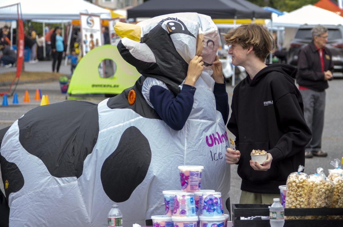 On Sunday, Sept. 22, sophomore Kiernan Renze has a staring contest with costumed sophomore Isaac Harrington while working for the Uhlman's Ice Cream food truck.