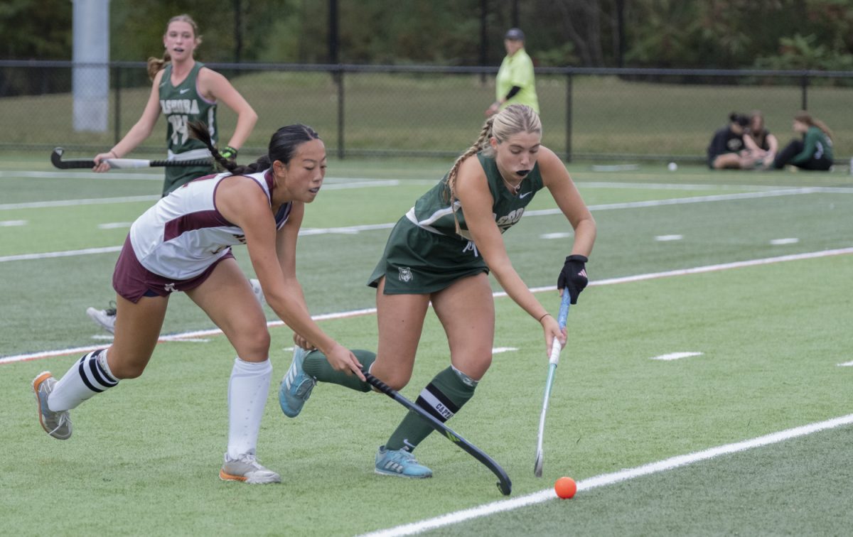 Senior Meredith Wu tries to steal the ball from the opposing team during the field hockey game against Nashoba on Sept. 23. 