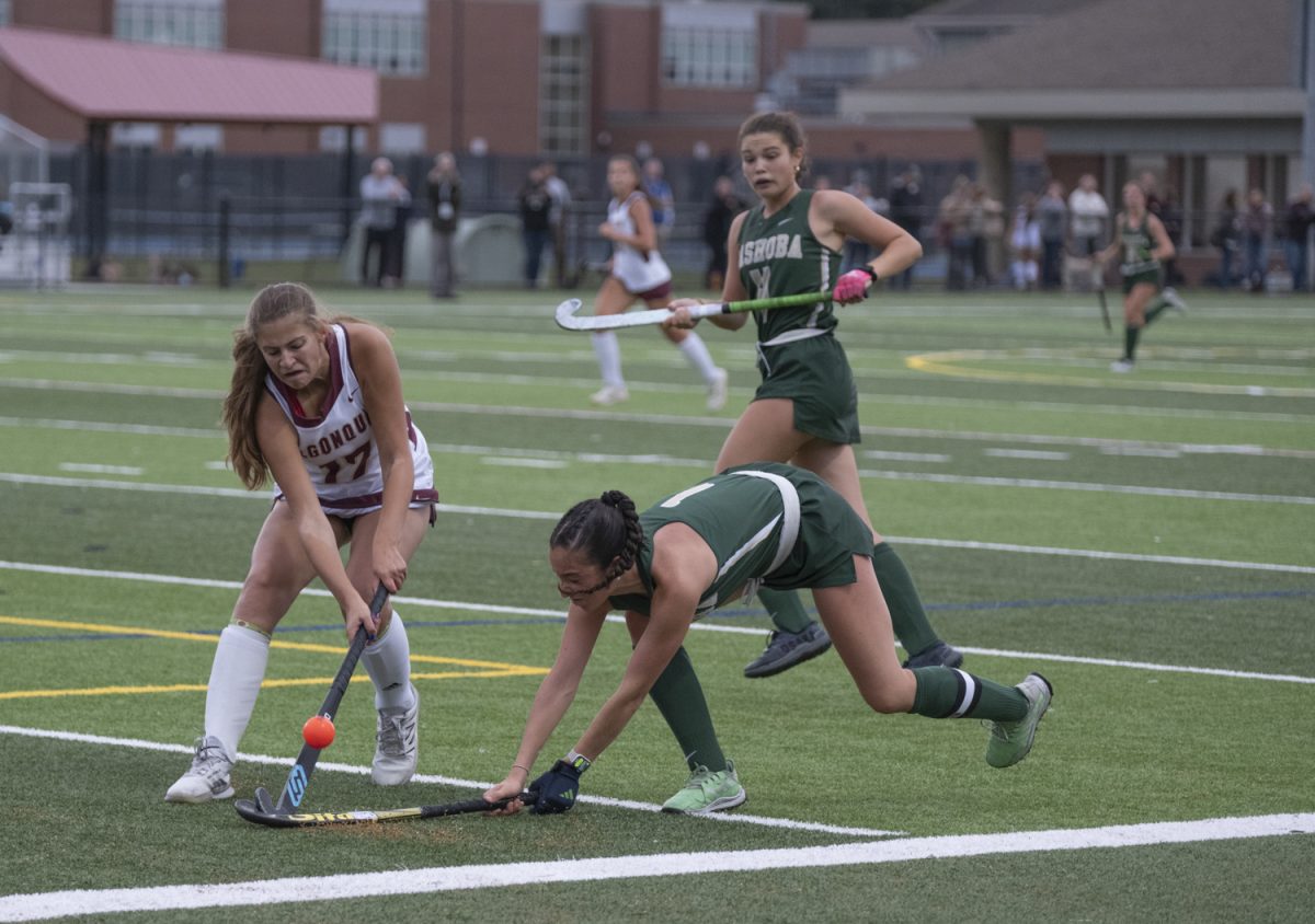 At the field hockey game against Nashoba on Sept. 23, junior Gabriella Moore prevents the opposing team from capturing the ball. Algonquin won 3-2 against Nashoba.