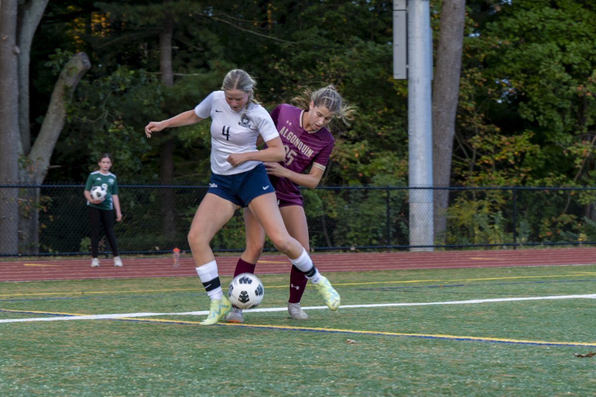 Senior Katie Richmond (25) fights for possession of the ball against Westborough senior Emily Gray.