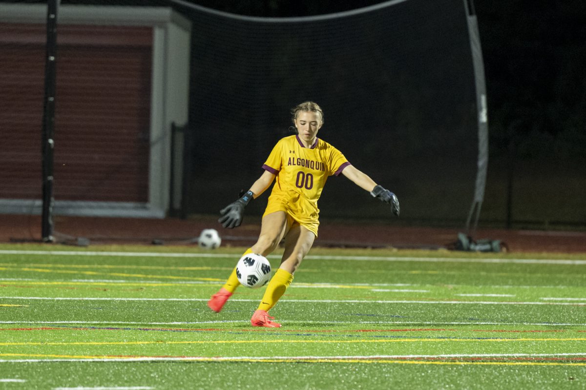 During their 3-1 win against Westborough on Sept. 24, senior goalie Amelia Bhistikul (00) kicks the ball down the field.