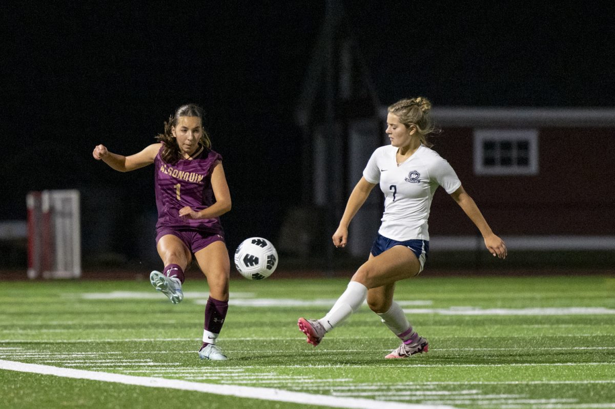 Junior Lily Dumont (1) kicks the ball up the field during the girls' soccer 3-1 win against Westborough.