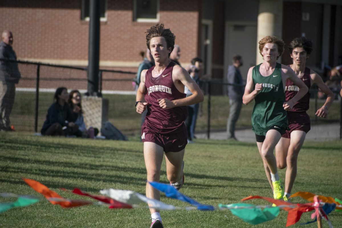 Senior Jonah Gould finishes first followed closely by his teammate sophomore Stephen Green.