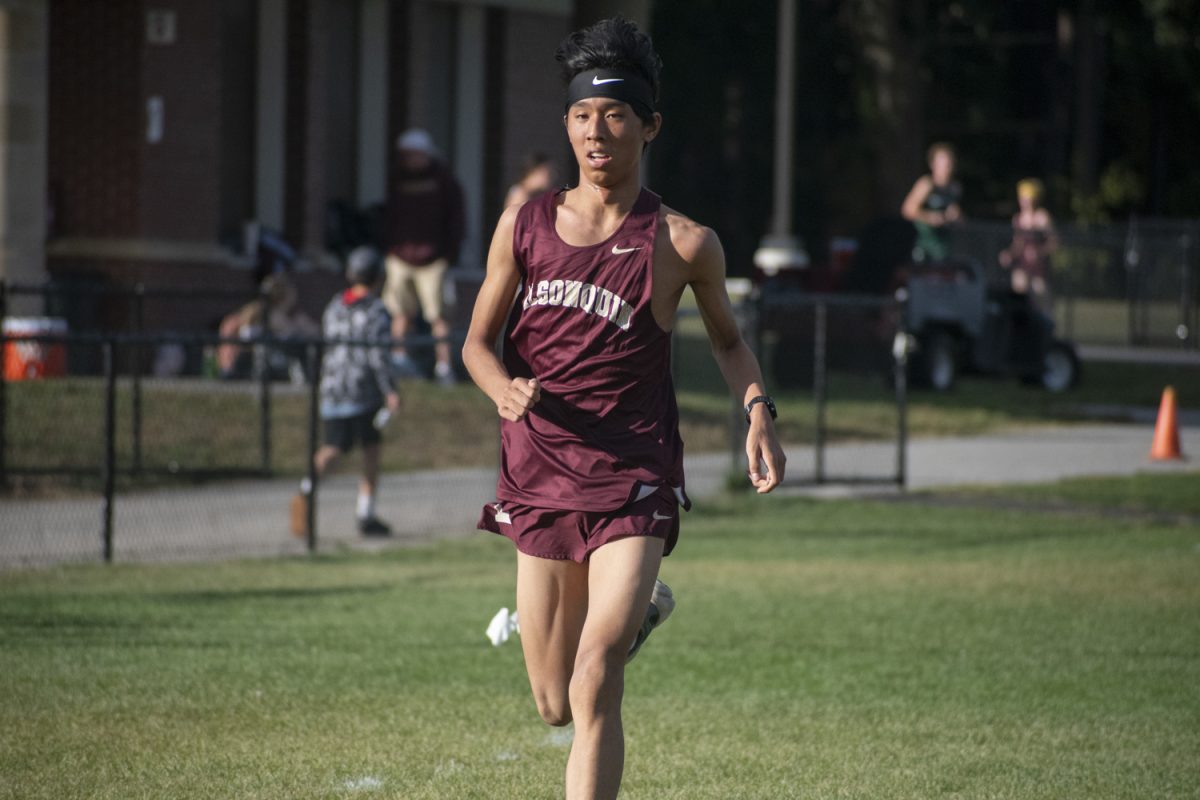 Senior Timothy Zhang finishes the race during the cross country meet at Algonquin on Sept. 24. 