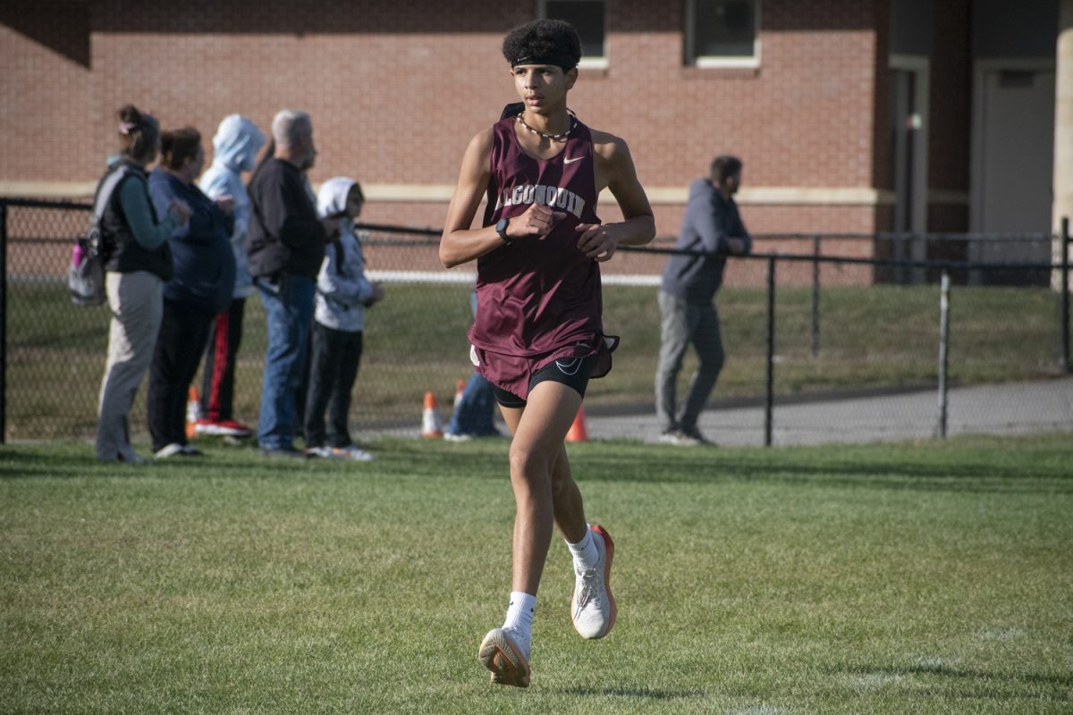 During the cross country meet at Algonquin, sophomore Jed Dilai runs three laps around the course on Sept. 24.