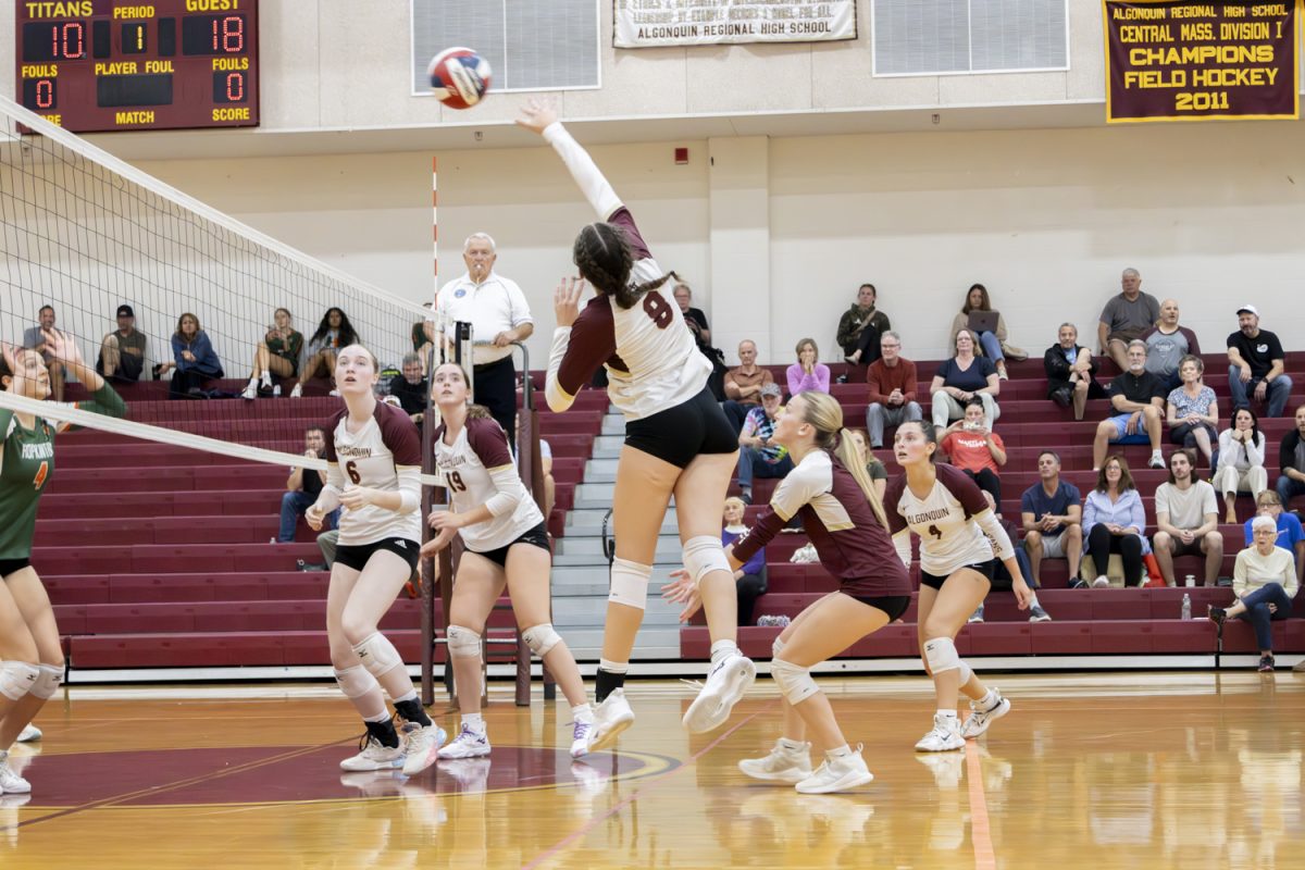 Sophomore Claire Wallace hits the ball over the net, returning the ball to Hopkinton's volleyball team during their game on Friday, Sept. 27, 2024.