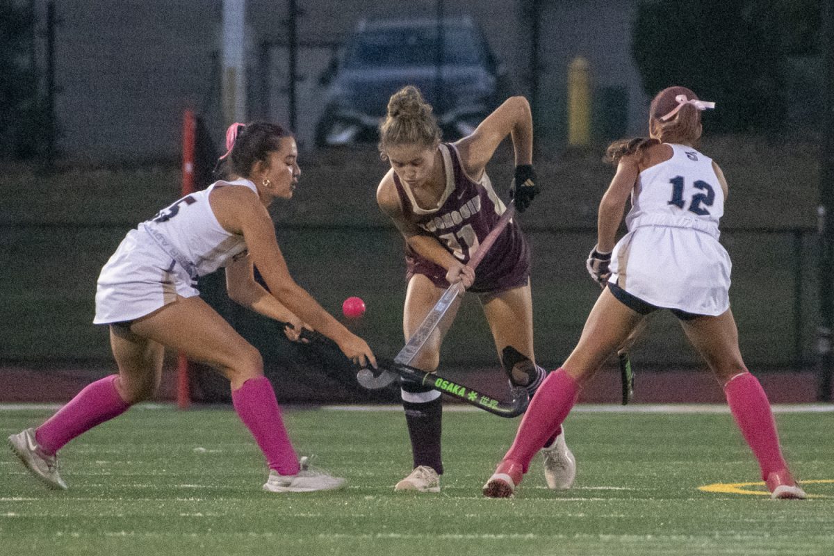 Senior Lindsey Brown, who scored the first of Algonquin's goals against Shrewsbury on Oct. 2 fights for the ball against two opposing players.