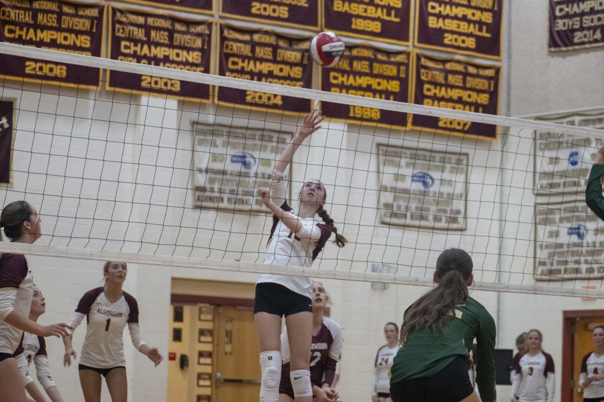 Junior Tessa Novello spikes the ball over the net onto the opposing team's side during the 3-0 win for Algonquin against Nashoba on Oct. 4.